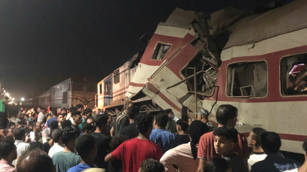 People surround two passenger trains which collided. Pic: AP