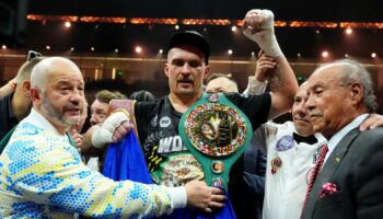 Oleksandr Usyk celebrates with the undisputed heavyweight title belt after his victory