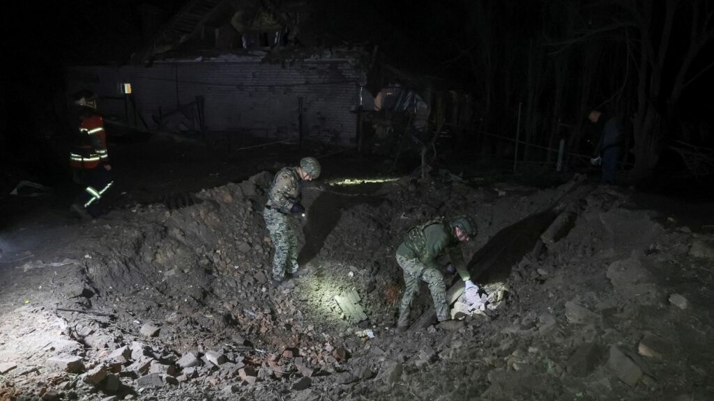 Police experts work at a site of a Russian air strike in Kharkiv on 20 September. Pic: Reuters