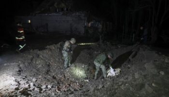 Police experts work at a site of a Russian air strike in Kharkiv on 20 September. Pic: Reuters