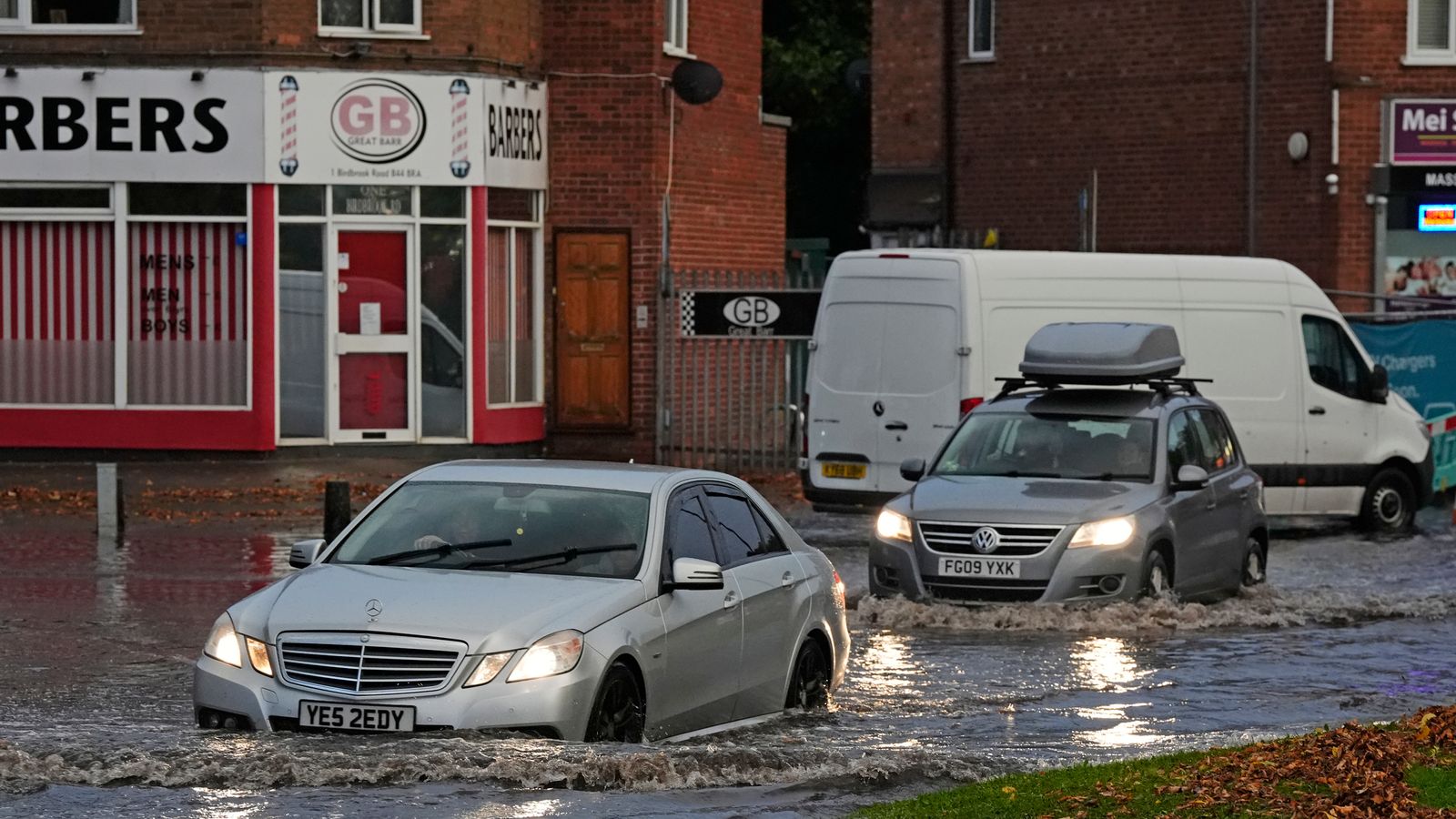 Vehicles drive through flood water in Perry Bar, Birmingham. Pic: PA