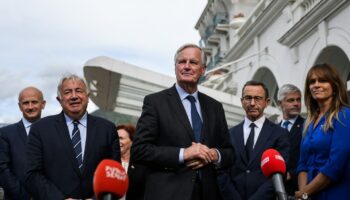 Le Premier ministre français Michel Barnier (C) s'adresse aux journalistes après avoir été accueilli par le chef du groupe parlementaire du parti Les Républicains (LR) au Sénat, à Paris, le 12 septembre 2024