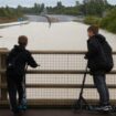 Young people look toward the A421 dual carriageway road after it was flooded following heavy rain, at Marston Moretaine near Bedford, Britain, September 23, 2024. REUTERS/Toby Melville