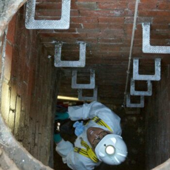 A Thames Water employee climbs down into a sewage pipe in London. File pic: PA