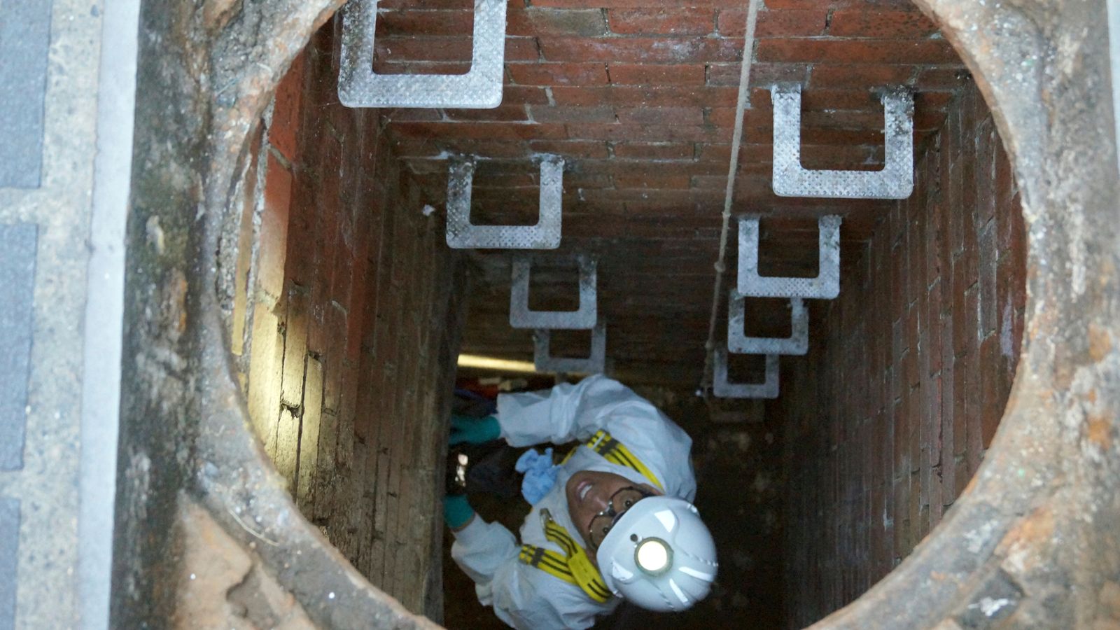 A Thames Water employee climbs down into a sewage pipe in London. File pic: PA