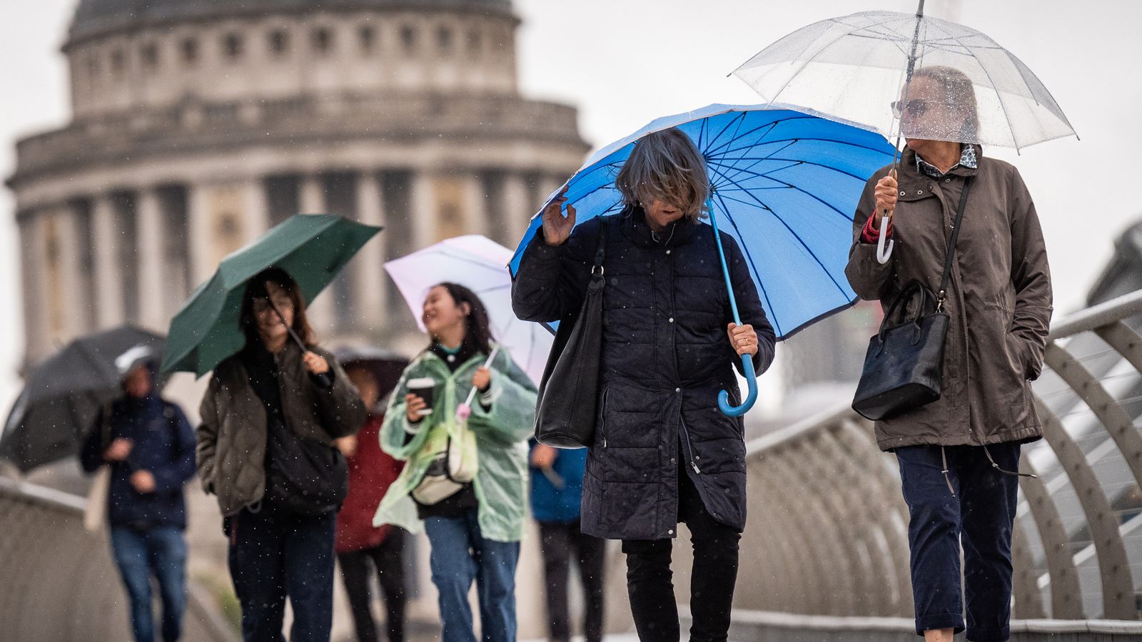 Umbrellas amid wind and rain in London on Friday. Pic: PA