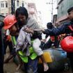 At least 170 dead after Nepal hit by flash flooding: Locals 'buried alive' as landslides sweep across country while families forced to wade through 'chest-deep' water to get to safety