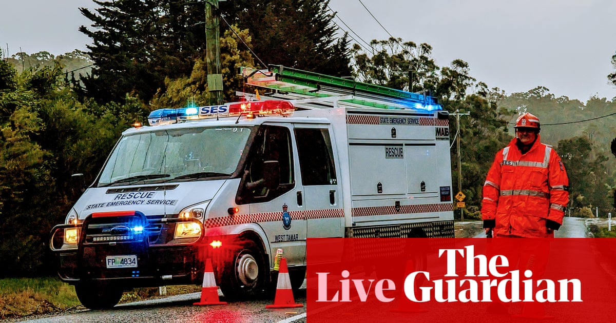 Australia news live: woman killed after tree falls on cabin; tens of thousands without power after night of wild storms