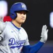 Shohei Ohtani of the Los Angeles Dodgers reacts after hitting a double against the Miami Marlins