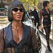 Naomi Campbell turns heads in a racy fishnet dress as she attends the Dolce & Gabbana show during Milan Fashion Week