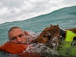 New footage shows dramatic moment sailor and his dog are rescued 20 miles off Florida coast after their boat sank in Hurricane Helene