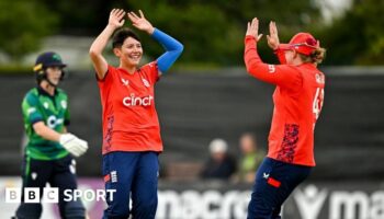 Issy Wong (left) and Hollie Armitage (right) celebrate a wicket for England against Ireland