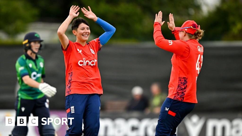 Issy Wong (left) and Hollie Armitage (right) celebrate a wicket for England against Ireland