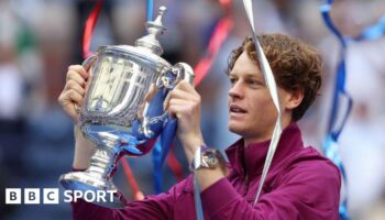 Jannik Sinner of Italy celebrates with the winners trophy after defeating Taylor Fritz