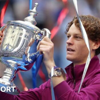 Jannik Sinner of Italy celebrates with the winners trophy after defeating Taylor Fritz