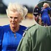 Windswept Queen Camilla battles the elements during a blustery visit to RAF Leeming in Northallerton