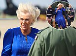 Windswept Queen Camilla battles the elements during a blustery visit to RAF Leeming in Northallerton