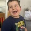 Woman, 41, is charged with murdering six-year-old boy at home in Swansea as tributes are paid to 'delightful, determined little boy'