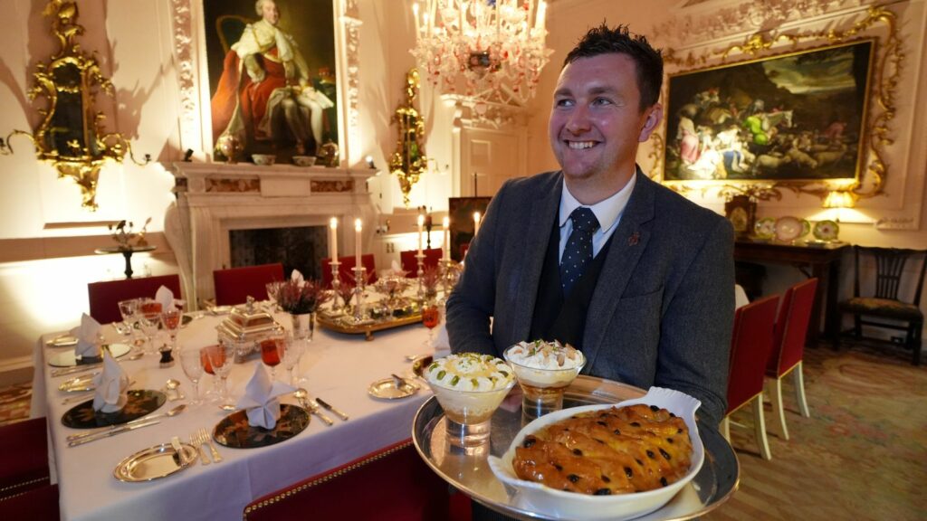 Evan Samson who leads the front of house team at Dumfries House with lemon and pistachio syllabub, bread and butter pudding alongside an apple and almond trifle in the Pink Dining Room - the King's favourite room at Dumfries House in Cumnock, Ayrshire - where members of the public are to be given the chance to enjoy an 18th century feast as part of a new bespoke dining experience, run by the King's Foundation charity. Picture date: Thursday October 10, 2024.