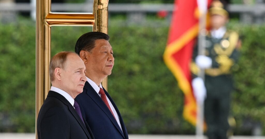 In this pool photograph distributed by the Russian state agency Sputnik, Russia's President Vladimir Putin and China's President Xi Jinping attend an official welcoming ceremony in front of the Great Hall of the People in Tiananmen Square in Beijing on May 16, 2024. (Photo by Sergei BOBYLYOV / POOL / AFP) / ** Editor's note : this image is distributed by Russian state owned agency Sputnik **