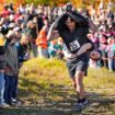 Nic Vinsonhaler carries Tara Rogowski while competing in the North American Wife Carrying Championship. Pic: AP Photo/Robert F Bukaty