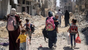 Palestinian women and their children walk though Jabalia in northern Gaza. File pic: AP Photo/Enas Rami