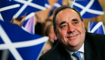 Scotland's then first minister Alex Salmond smiles surrounded by national flags in 2007. Pic: Reuters