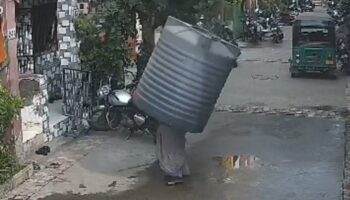 Video captures water tank falling on woman — but she miraculously escapes injury