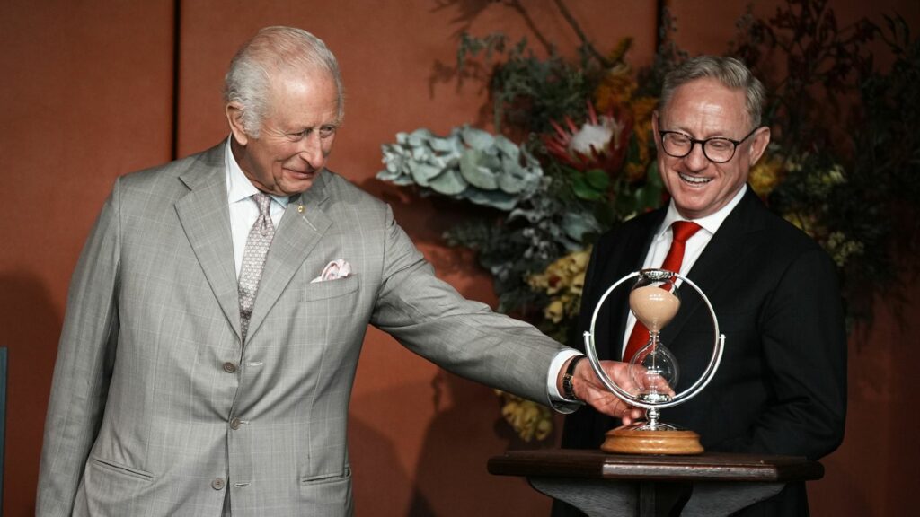 President of the Legislative Council, Ben Franklin (right), watches as King Charles III turns an hourglass he is presenting as a gift to mark the Bicentenary of the New South Wales Legislative Council, during an event marking the anniversary at New South Wales Parliament House, in Sydney, on day one of his visit to Australia and Samoa. The specially commissioned hourglass was handmade at The Goldsmith's Centre, with the wooden base supplied by The King's Foundation from a cedar tree at his Highg