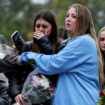 Fans comfort one another at the London vigil on Sunday. Pic: Reuters