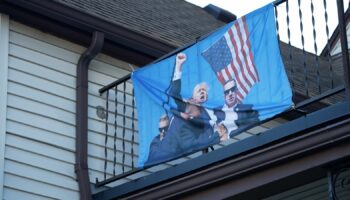 A flag depicting the attempted assassination of Trump at a Michigan home