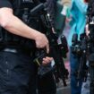 leeds, United Kingdom – May 05, 2019: Horizontal shot of armed police patrolling tour de yorkshire crowd to keep everyone safe