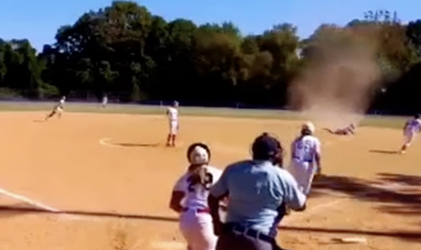 Virginia softball player contends with dust devil as she makes diving play for out