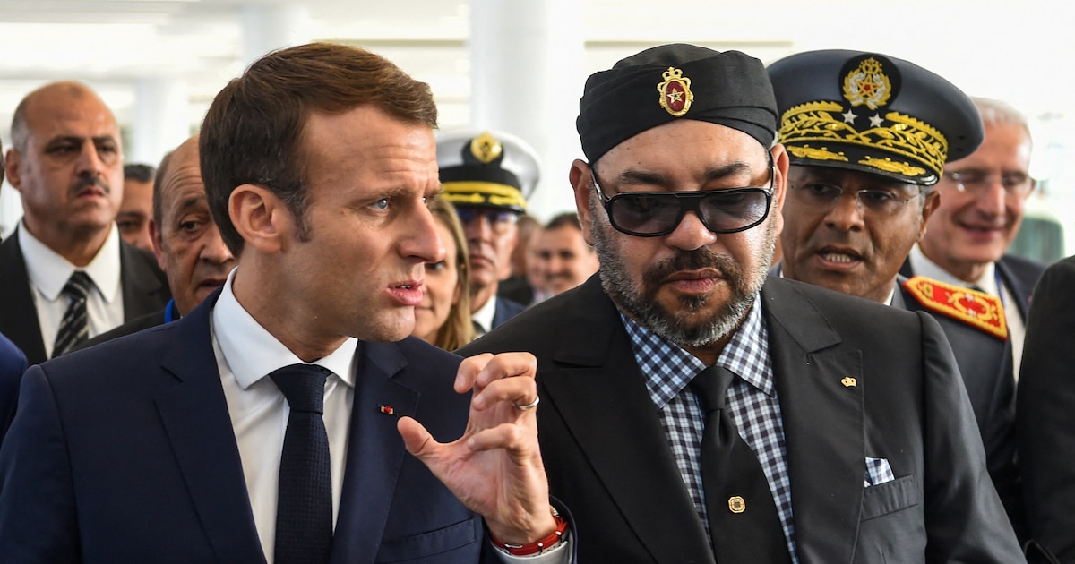 French President Emmanuel Macron (C-L) gestures as he speaks with Morocco's King Mohamed VI (C-R) upon their arrival at Rabat Agdal train station for the inauguration of a high-speed railway line on November 15, 2018. French President Emmanuel Macron visits Morocco to take part in the inauguration of a high-speed railway line that boasts the fastest journey times in Africa or the Arab world. (Photo by FADEL SENNA / AFP)