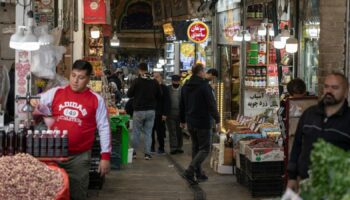 People go about their daily lives after the Israeli retaliatory strike in Iran. The airstrike has left many of the country's inhabitants undaunted. Pic: AP