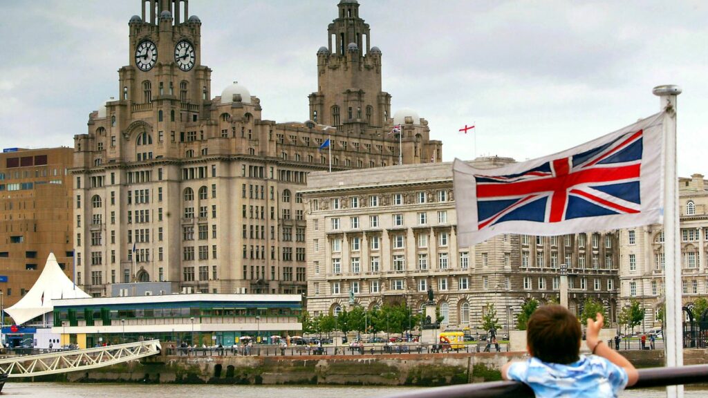 A young passenger looks at the Liverpool skyline as the Mersey Ferry comes into dock. Pic: Reuters