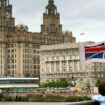 A young passenger looks at the Liverpool skyline as the Mersey Ferry comes into dock. Pic: Reuters