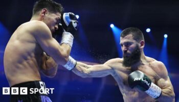 Artur Beterbiev lands a right hook on Dmitry Bivol