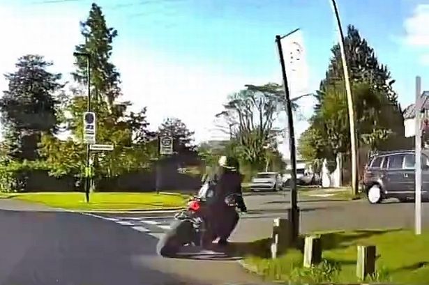 Car passenger flung to ground 'by motorcyclist in road rage hit-and-run attack'