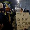 Protestors holding 'Justice for Chris Kaba' signs gather outside the Old Bailey after Met marksman who shot him dead is found not guilty of murder - as police release footage of moment officer opened fire