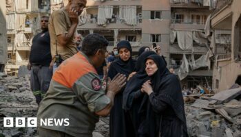 Rescue workers search for signs of missing under rubble