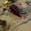 Terrifying moment cars are swept away as roads become rivers in Spain: Rescuers searching for missing people after cities were smashed with golf ball-sized hailstones