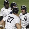 New York Yankees shortstop Anthony Volpe (right) celebrates after hitting a grand slam in game four