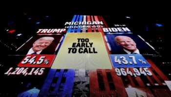 A giant screen shows a broadcast of the 2020 election in Michigan. Pic: Reuters