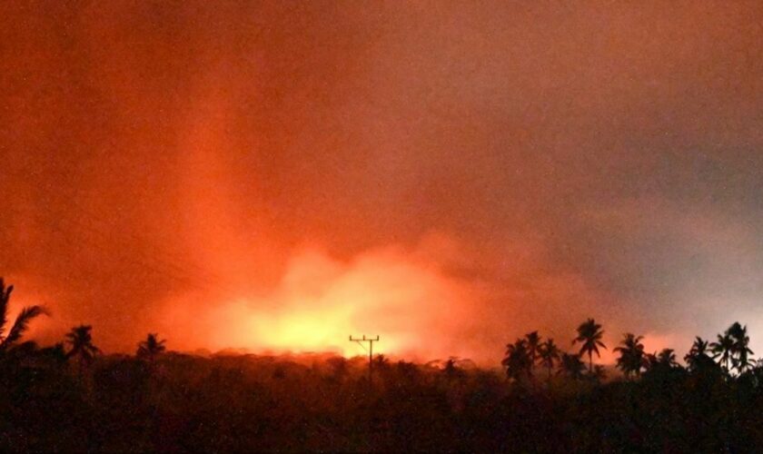 In this photo made available by Indonesia's Center for Volcanology and Geological Disaster Mitigation Agency (PVMBG) of the Ministry of Energy and Mineral Resources, the sky glows from the eruption of Mount Lewotobi Laki-Laki early Monday, Nov. 4, 2024, in East Flores, Indonesia. (PVMBG via AP)