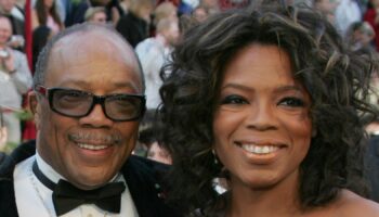 Music producer Quincy Jones (C), with his unidentified date and Oprah Winfrey (R), arrives at the 77th annual Academy Awards in Hollywood, February 27, 2005. REUTERS/Lucy Nicholson MM