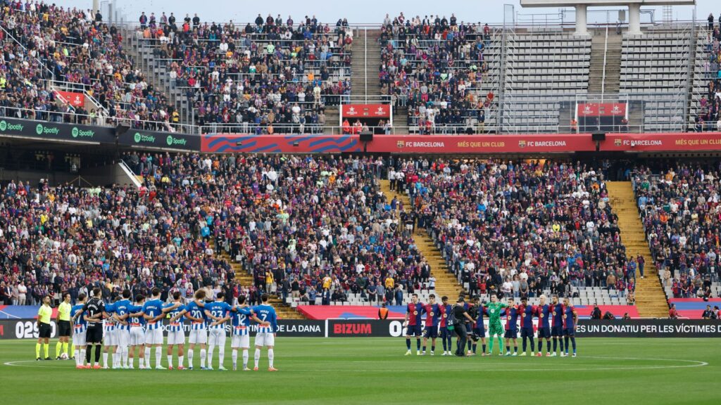 Players observe a minute's silence for the flood victims ahead of Barcelona v Espanyol on Sunday. Pic: AP