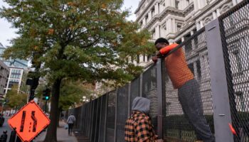 Workers put up security fencing near the White House on Monday. Pic: Reuters