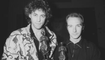 Midge Ure (R), 31, of the rock group Ultravox, with Bob Geldof at the Ivor Novello Awards for 1984 at the Grosvenor House Hotel, London. The pair won a joint award for the Band Aid single 'Do They Know It's Christmas?"