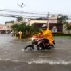 A motorcyclist in a flooded street in La Ceiba, Honduras. Pic: Reuters